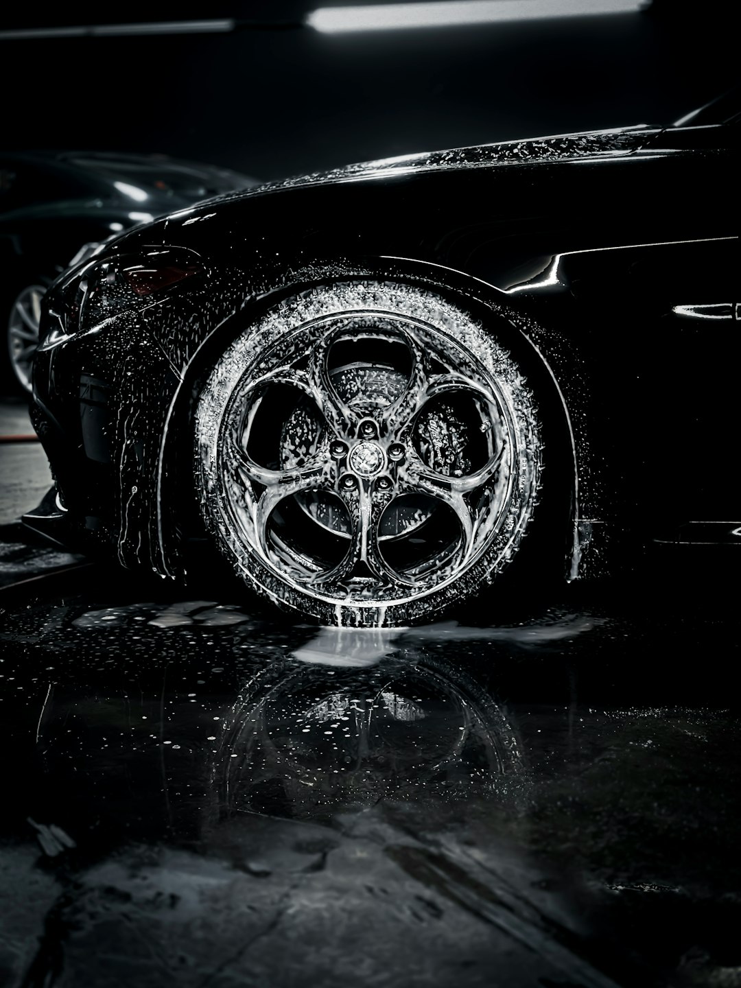 a-close-up-of-a-car-tire-on-a-wet-surface-m5g2ifroucs